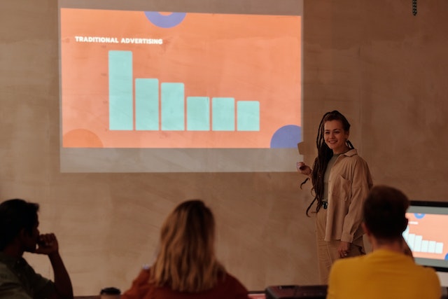 A woman presenting traditional advertising